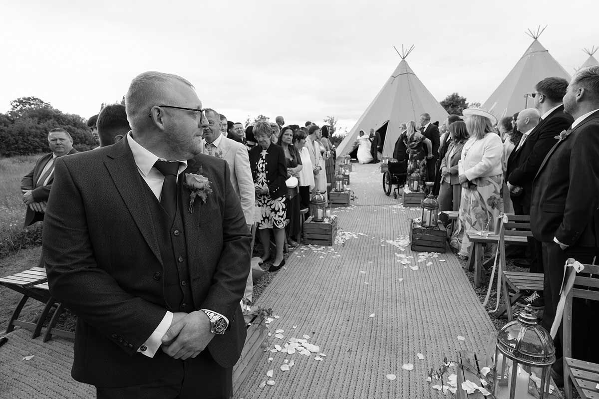 wedding photography at the den at four acre- the groom gets his first nervous look of his beautiful wife to be