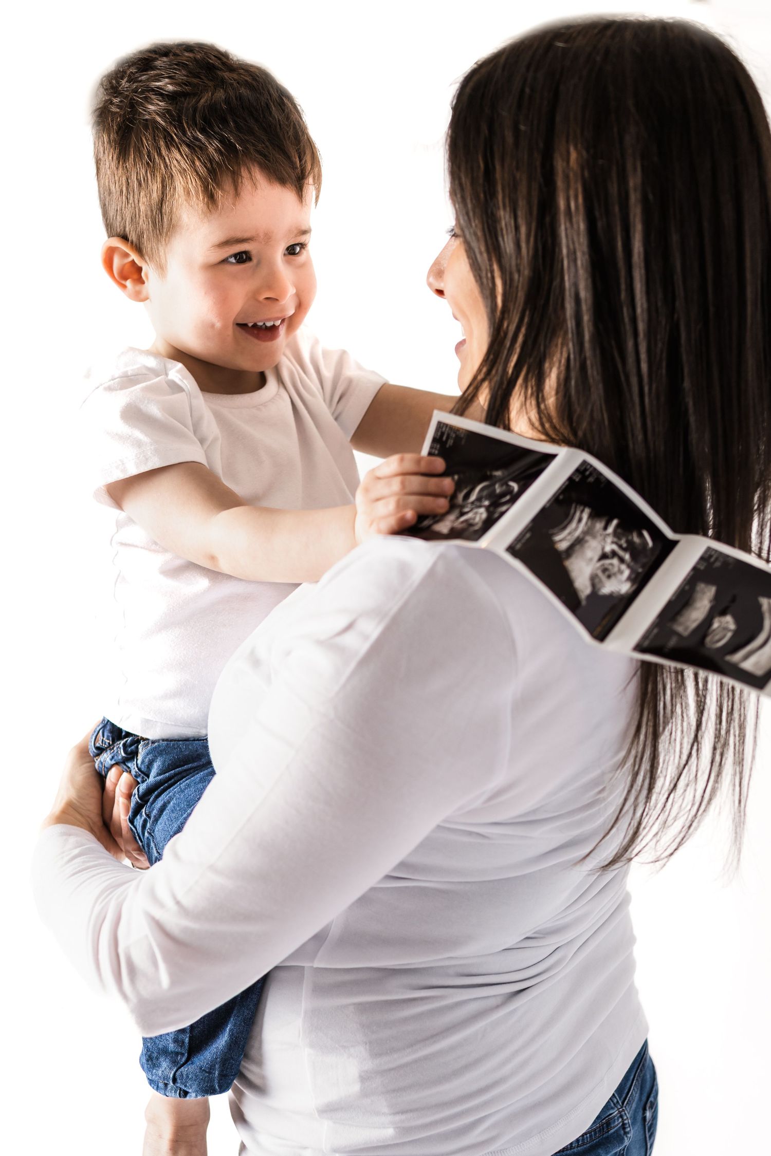 studio maternity session mom son ultrasound on white