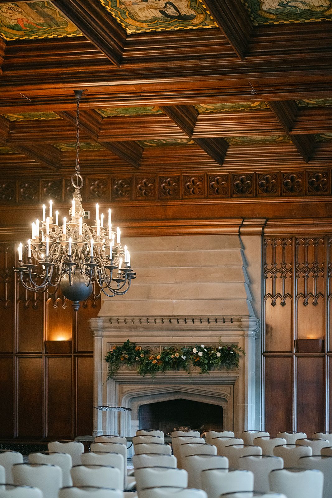 Elegant wedding ceremony venue with ornate wood-paneled walls, chandelier, stone fireplace. - University Club of Chicago Wedding Ceremony