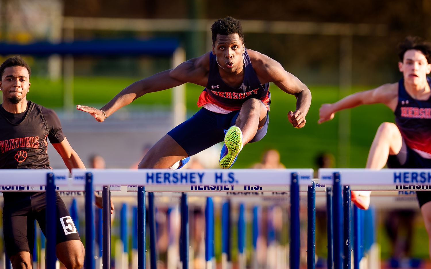 Hershey Trojans hurdler clearing a hurdle on the home track, by Deanna Fox, SportsFox Photography, Hershey PA