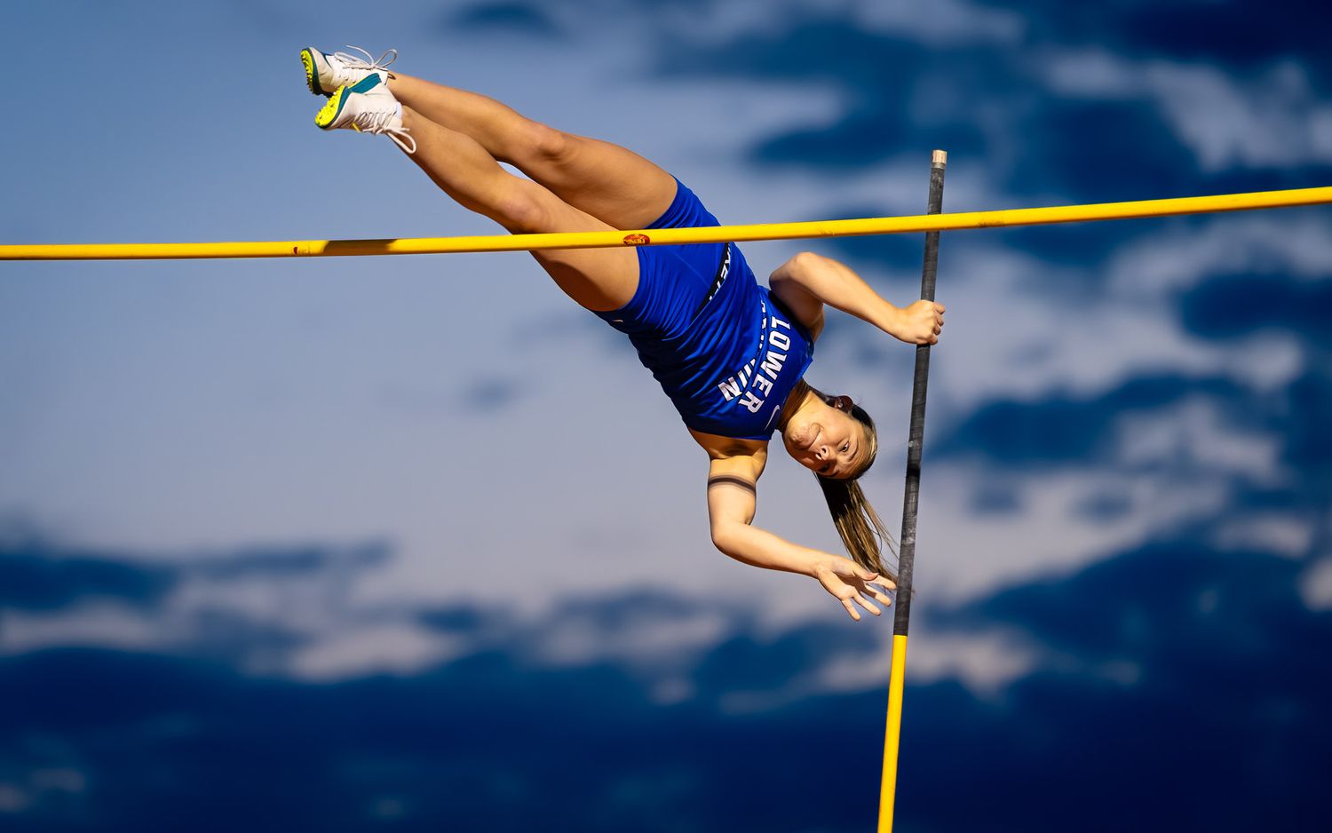 Lower Dauphin pole vaulter arching over the bar at the Meet of Champions, by Deanna Fox, SportsFox Photography, Hershey PA