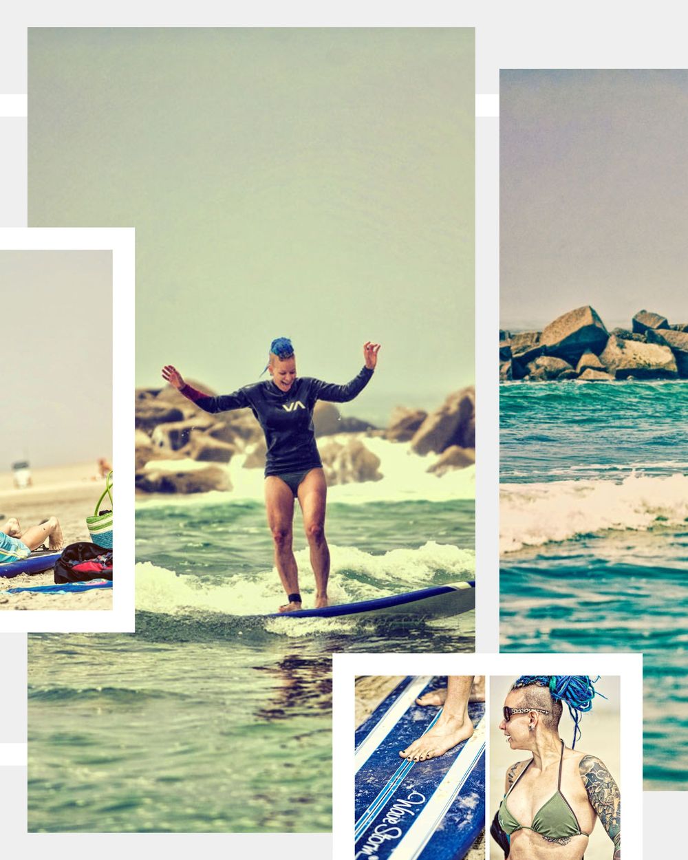 Woman with blue hair triumphantly standing on a surfboard riding a wave at the beach.