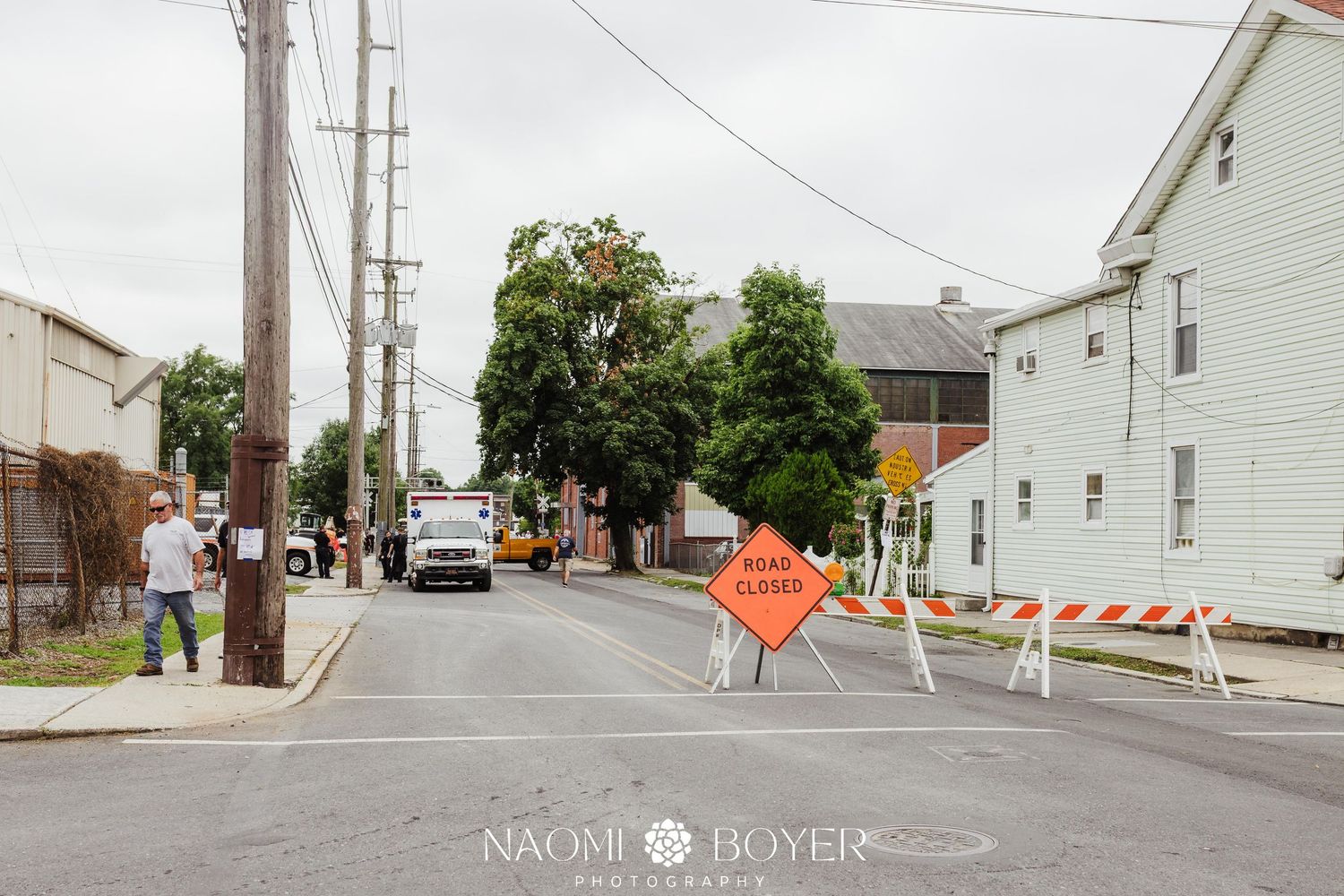 Road closure signs and orange barricades block a residential street in Lebanon, PA during Big Boy train day at the railroad crossing.