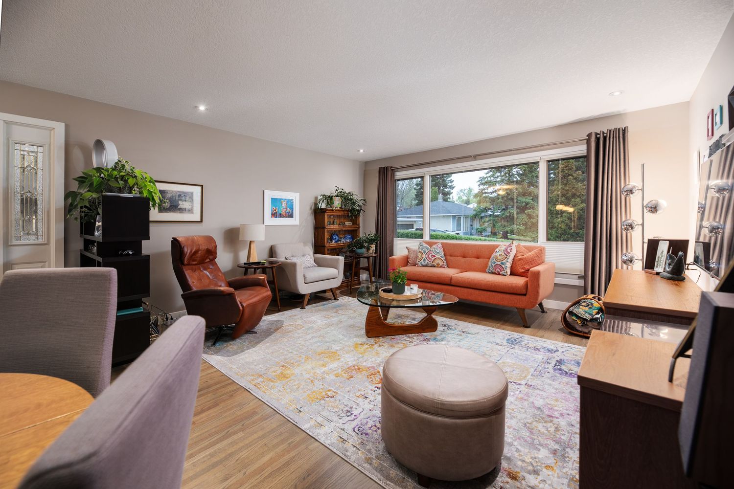 Bright Calgary living room with large windows, real estate photography by RezinMedia