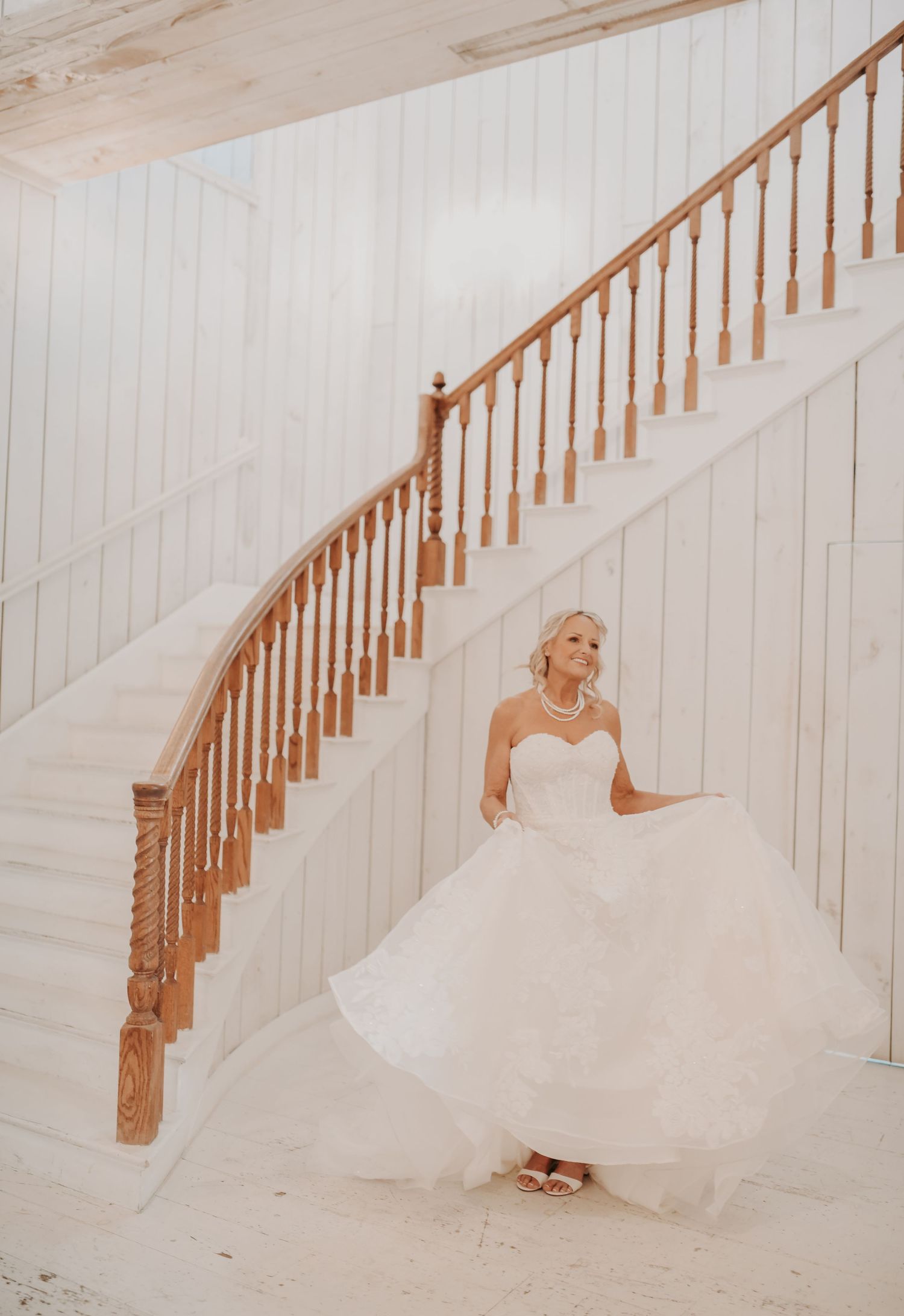 Bride showing the train of her lace wedding gown during bridal portraits
