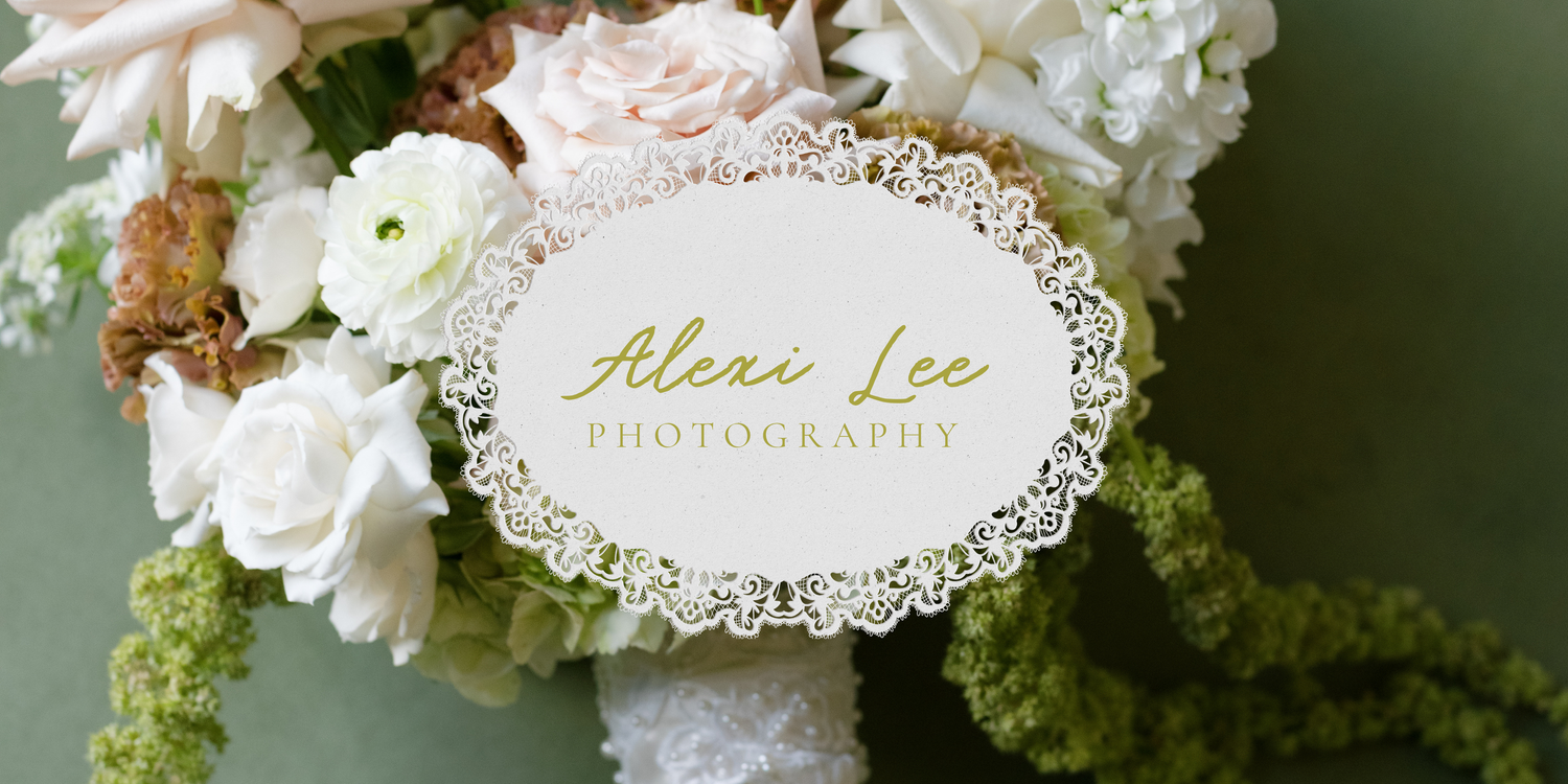 Alexi Lee Photography logo on a white lace card among white flowers.