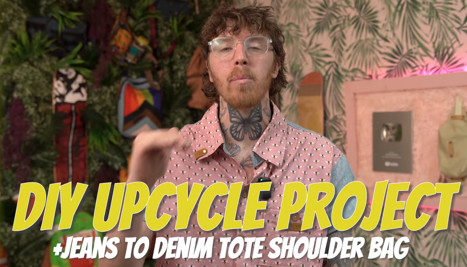 Tattooed person presenting a DIY upcycle project tutorial on converting jeans into a denim tote shoulder bag.