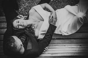 A series of black and white photos showing someone lying on wooden planks in various artistic poses.