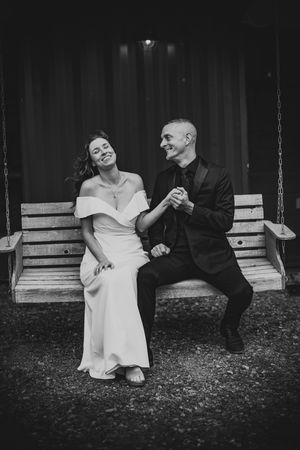 Black and white photo series of a couple sitting on a porch swing showing playful romantic moments.