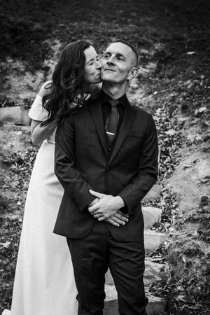 Black and white photos capturing intimate moments between a couple embracing outdoors.