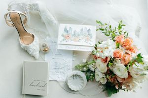 Elegant wedding invitation suite with floral arrangements and delicate paper details in soft pastel colors.