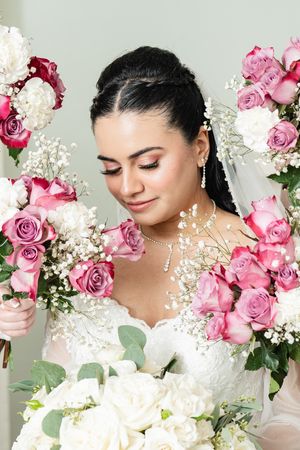 Romantic floral portrait with pink roses and white baby's breath flowers creating an ethereal spring atmosphere.