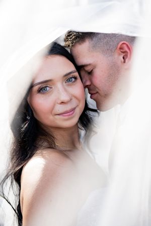 Romantic close-up shots of a couple through soft white veil material.