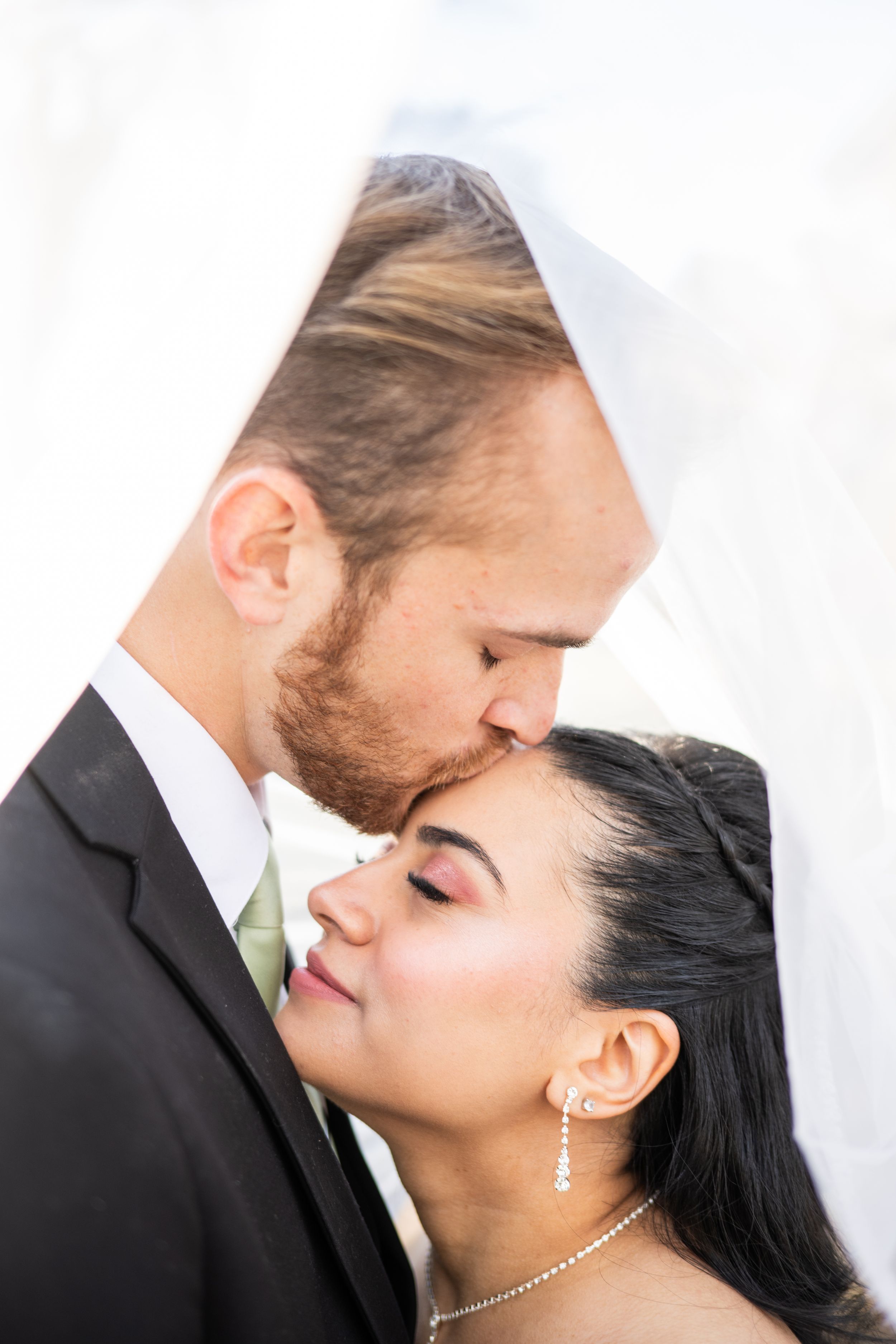 A romantic close-up sequence shows a couple sharing tender moments against a light background.