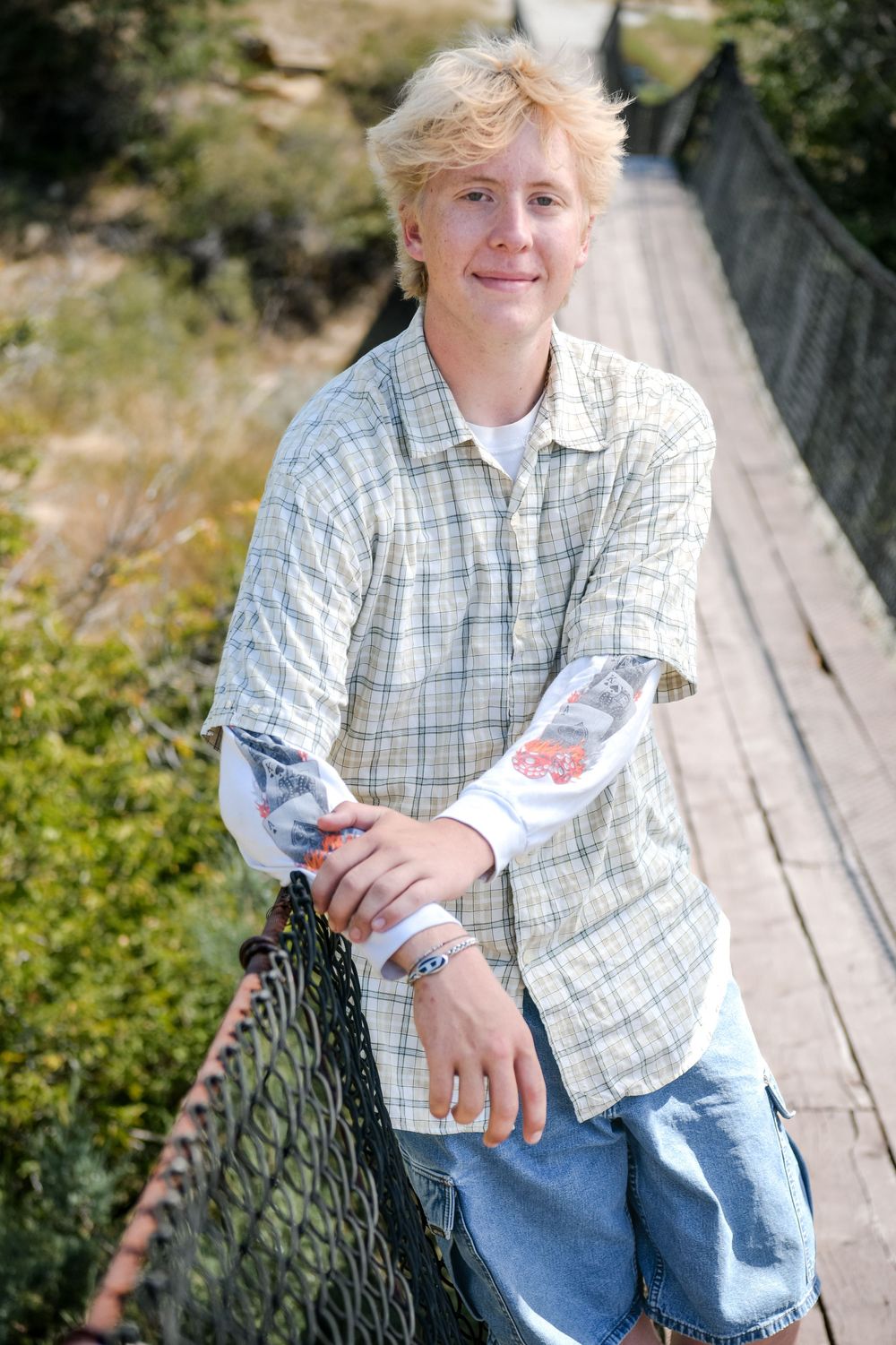 A series of casual outdoor portraits showing someone in a plaid shirt and jeans sitting on a wooden bench.