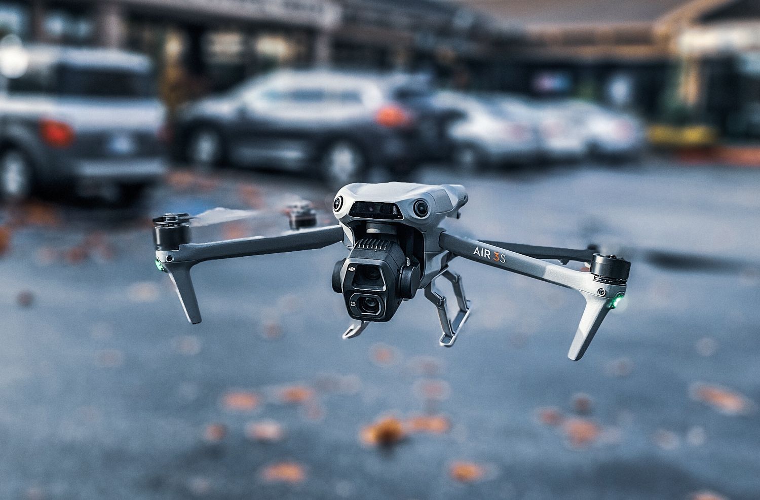 White drone with camera hovering in indoor space with clean minimal background.