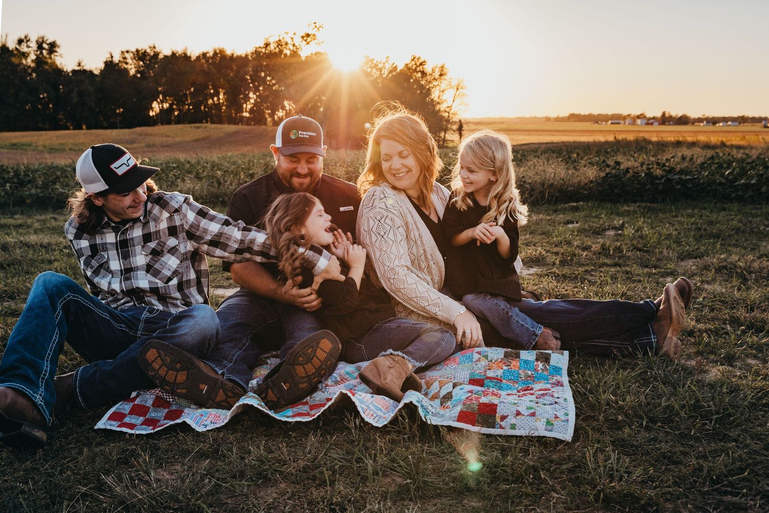 Tender family moment captured outdoors during golden hour.