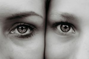 Artistic black and white close-up of two eyes side by side.