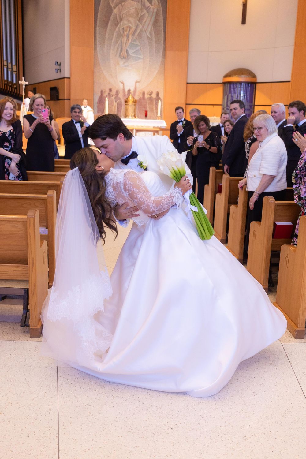 A romantic wedding sequence shows a couple sharing a dip kiss in a church setting.