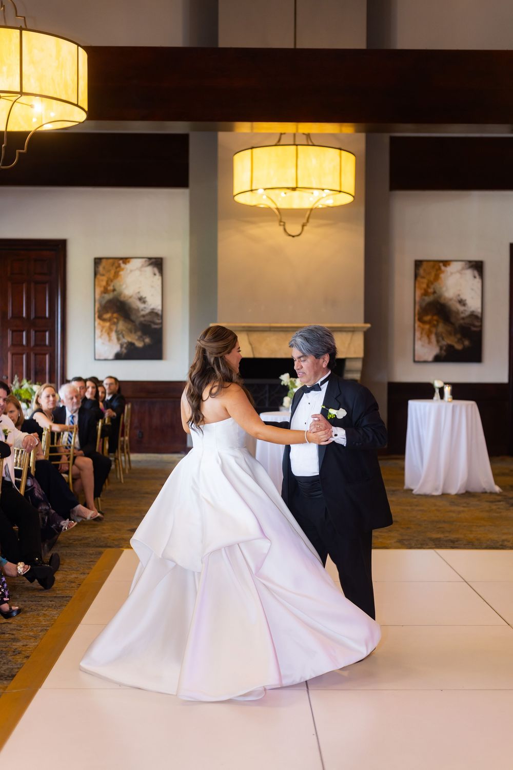 A sequence of dance moves during a wedding reception shows the bride's white dress flowing gracefully across the dance floor.