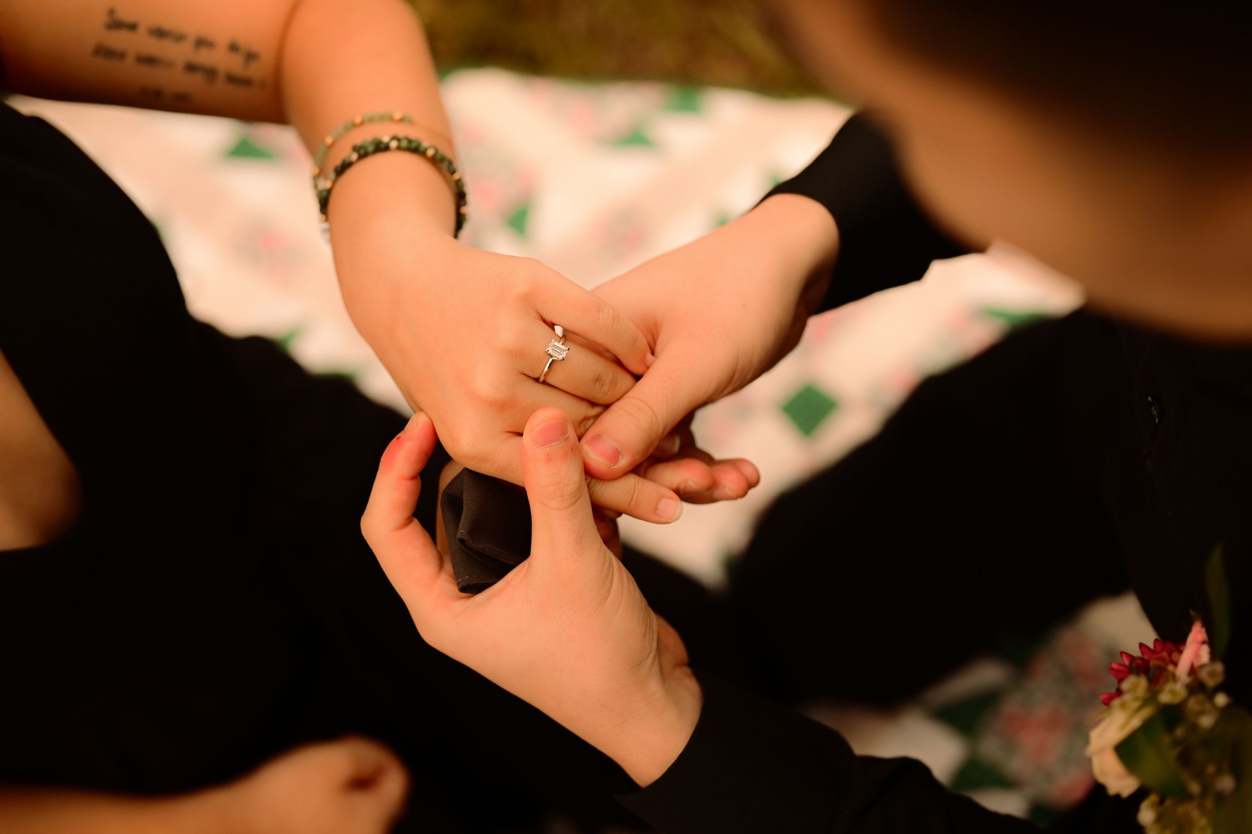 Hands performing various sign language gestures against a dark background with soft lighting.