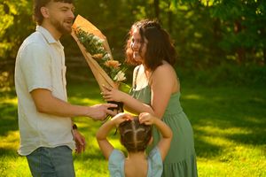 A joyful embrace and celebration in a sunlit garden after a romantic proposal moment.