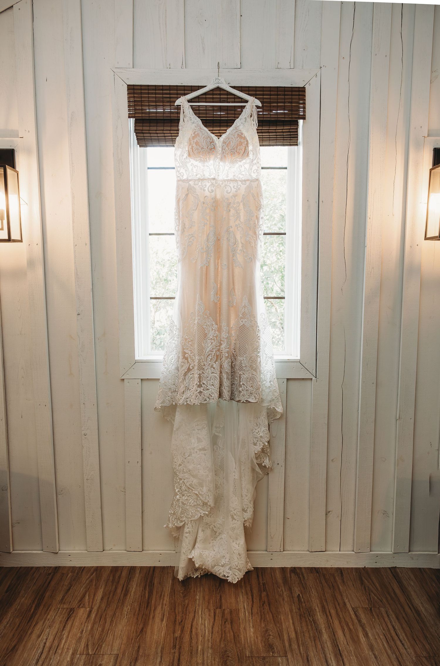 Lace wedding dress hung over window