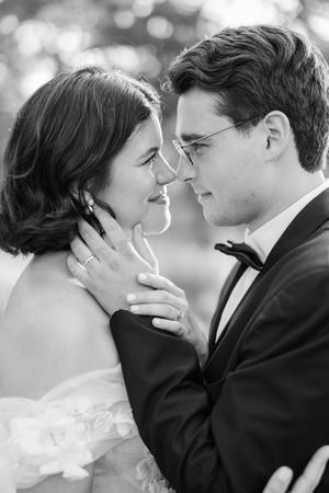 A romantic black and white wedding photo series showing tender moments between the newlyweds in close-up shots.