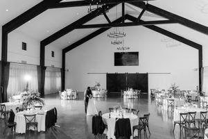A series of black and white photos showing an empty wedding venue with high vaulted ceilings and exposed beams.