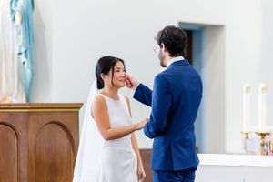 A couple shares an intimate dance moment together during a wedding celebration in an elegant venue.