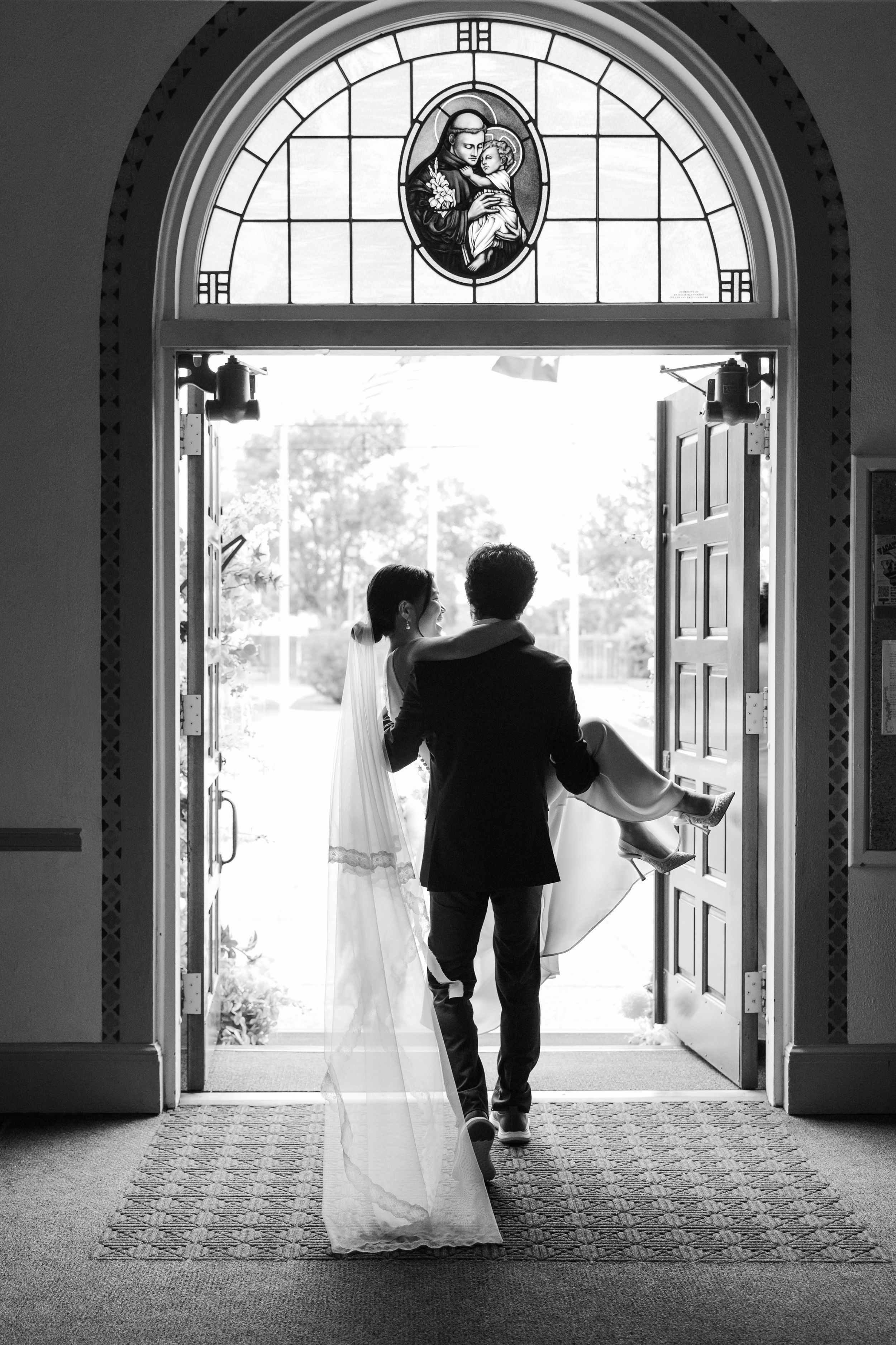 A wedding couple is silhouetted against bright arched doorways in a progression of black and white photographs.