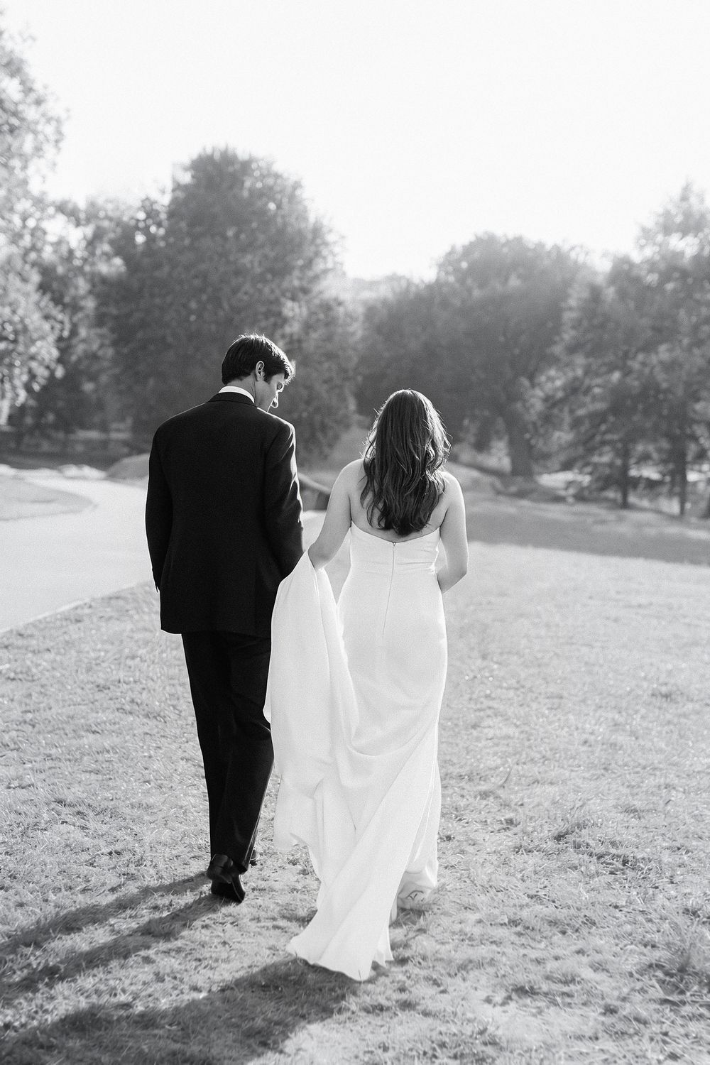 Bride and groom walking together in a romantic black and white wedding portrait in Knoxville, Tennessee.