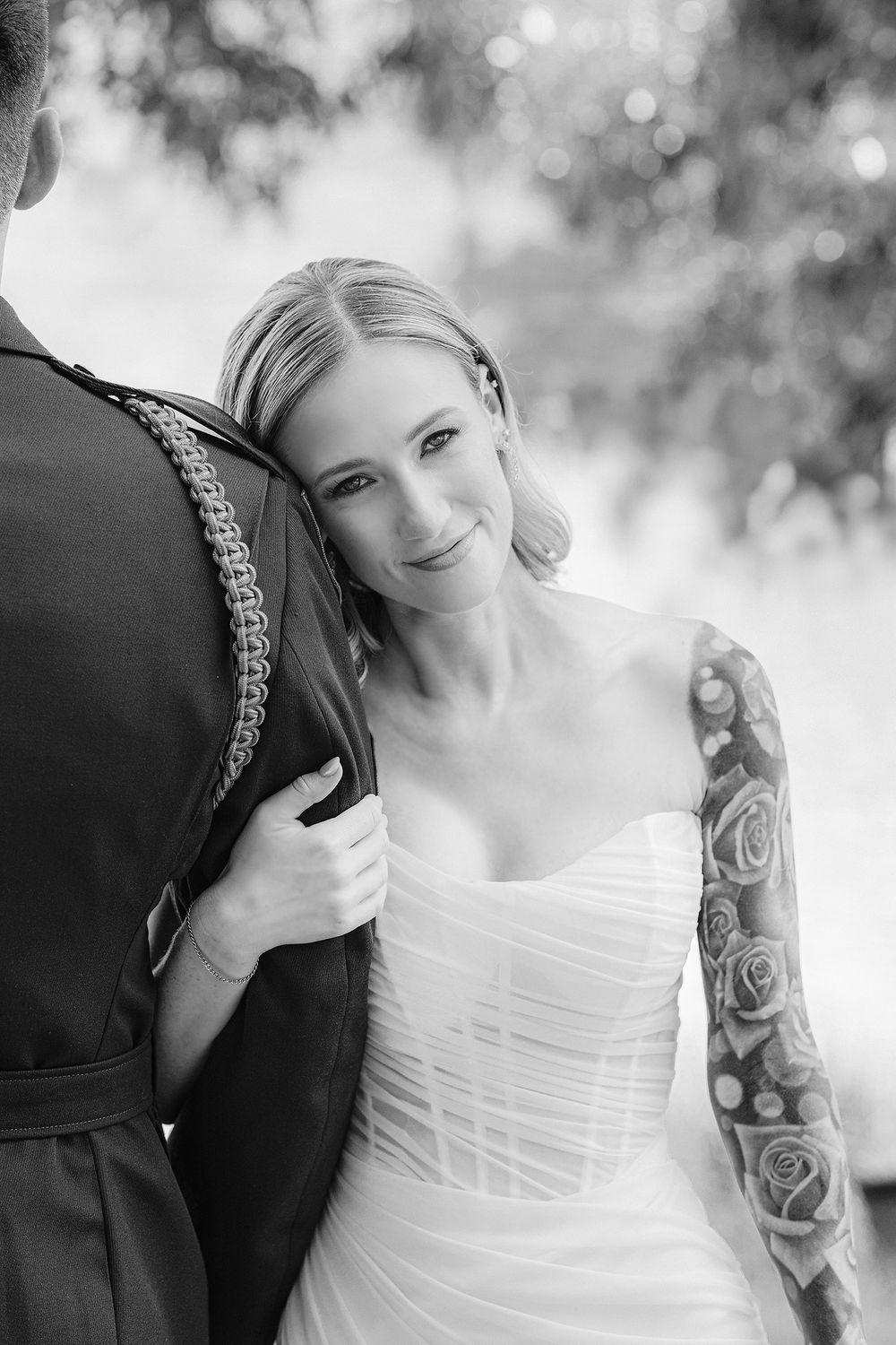 Bride leaning on groom’s shoulder during their Lewallen Farms wedding in Georgia, photographed in black and white by Juhi Photography.