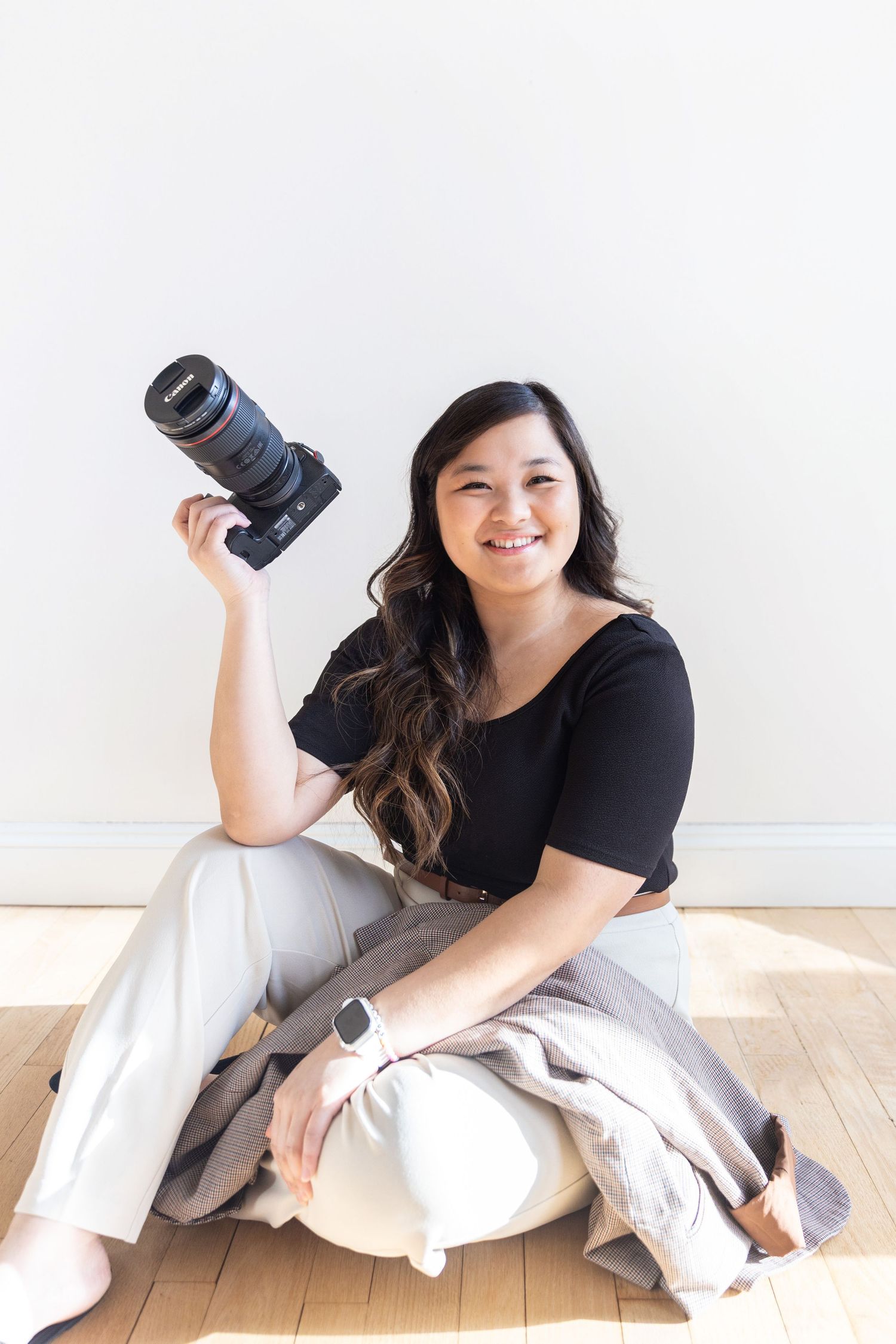 The woman behind LivingFlow smiling during a photography studio session.