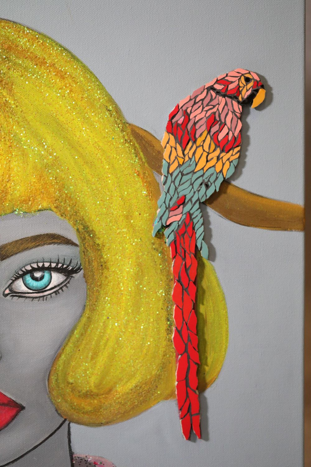 Artistic illustration featuring a bright yellow hairstyle with a colorful parrot ornament and turquoise eye detail.