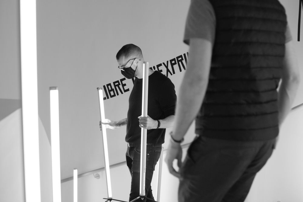 Black and white behind-the-scenes photo of people working on a film set.