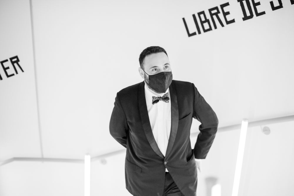 Professional black and white photoshoot in a minimalist studio setting with formal attire.