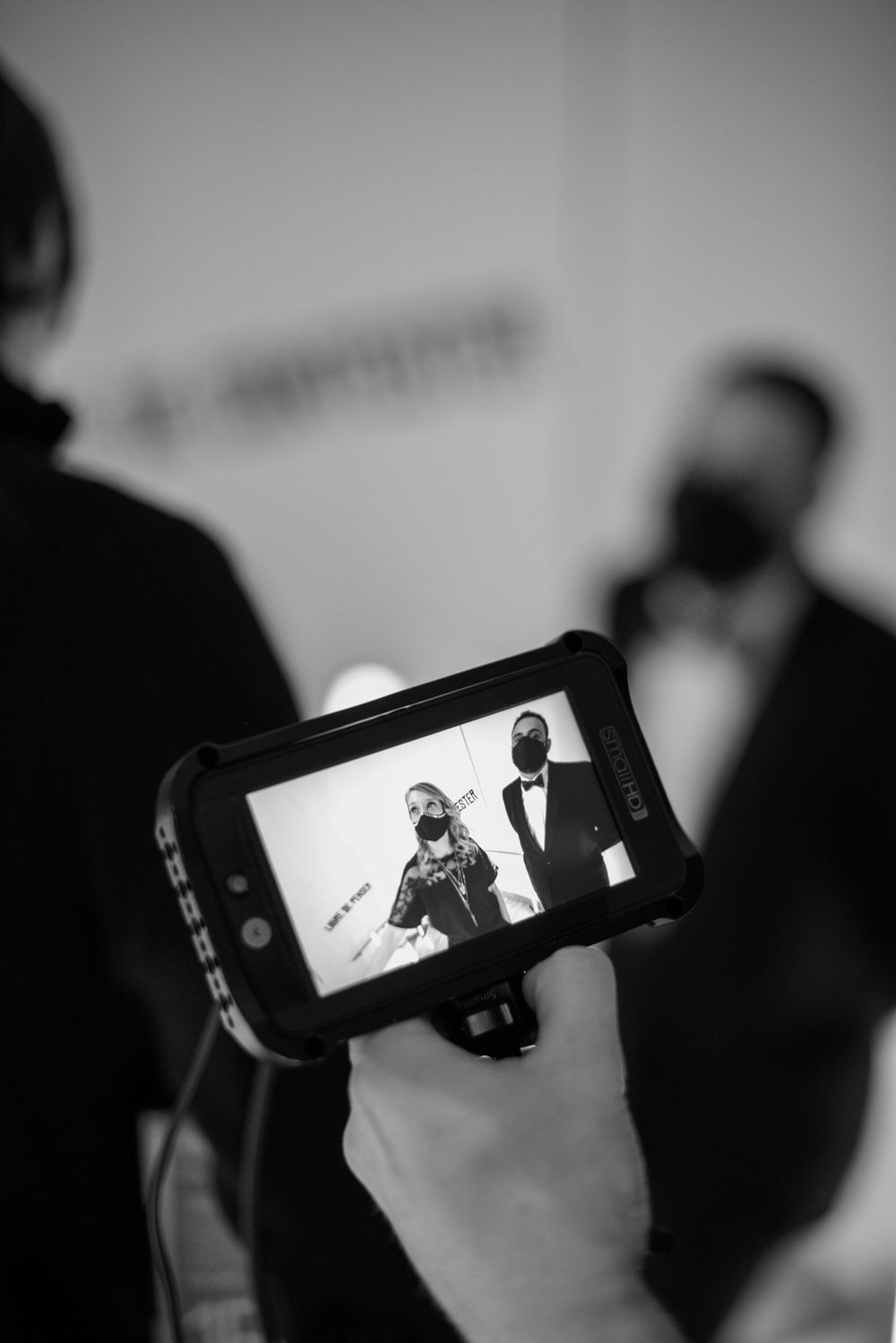 Mobile phones recording video footage in a dark room during production.