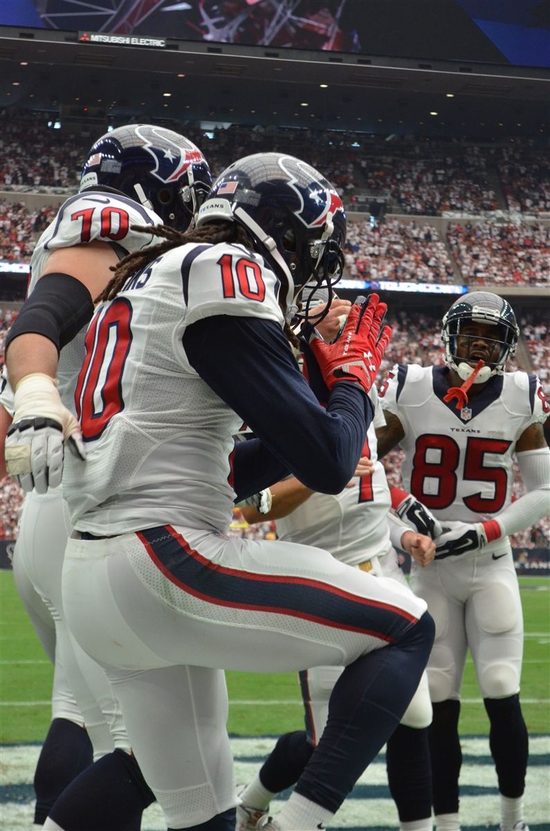 Houston Texans players celebrate in the endzone during an NFL football game.