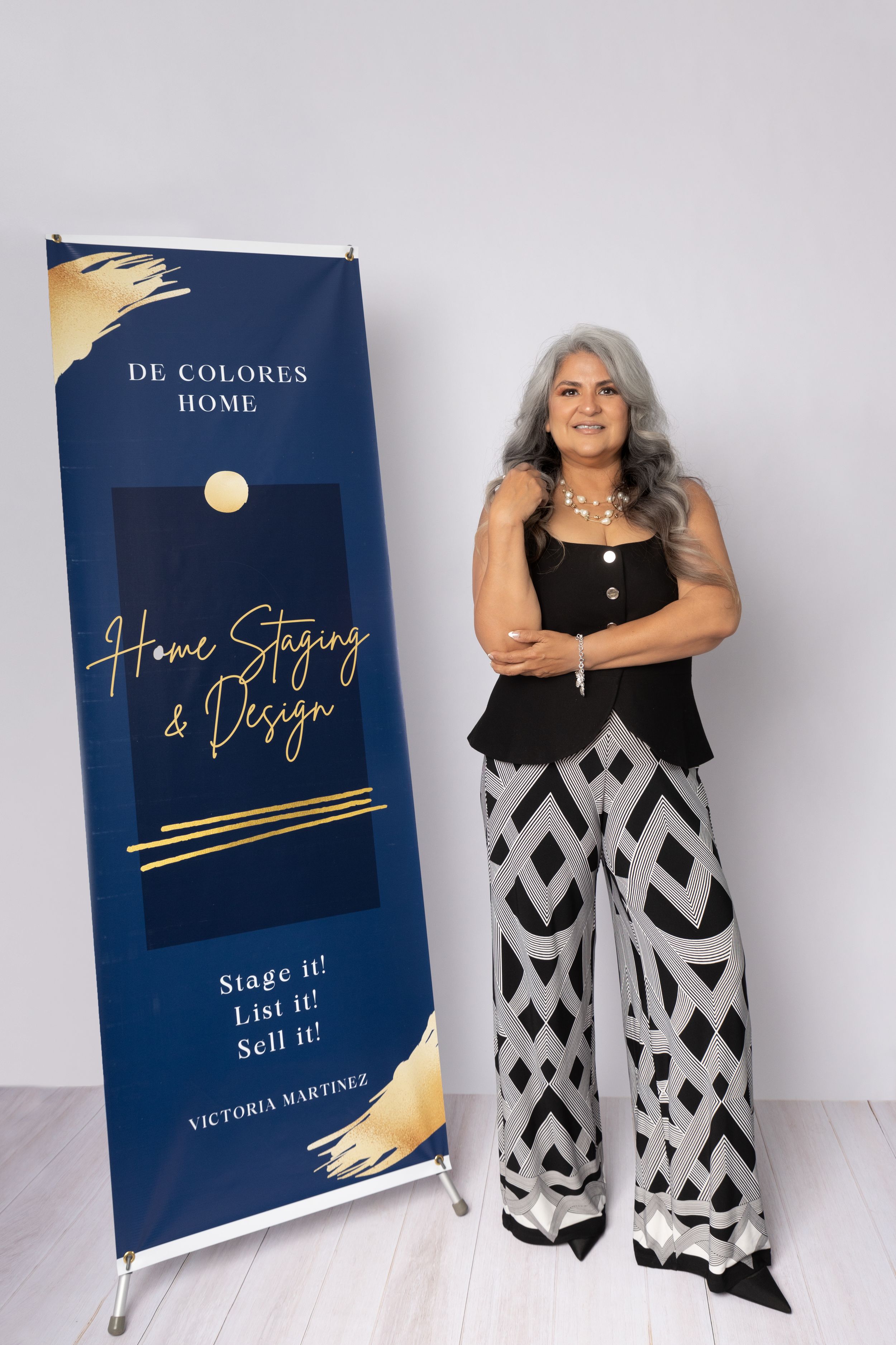 A collection of marketing materials featuring navy blue notebooks with gold text and a person wearing black and white geometric pants.