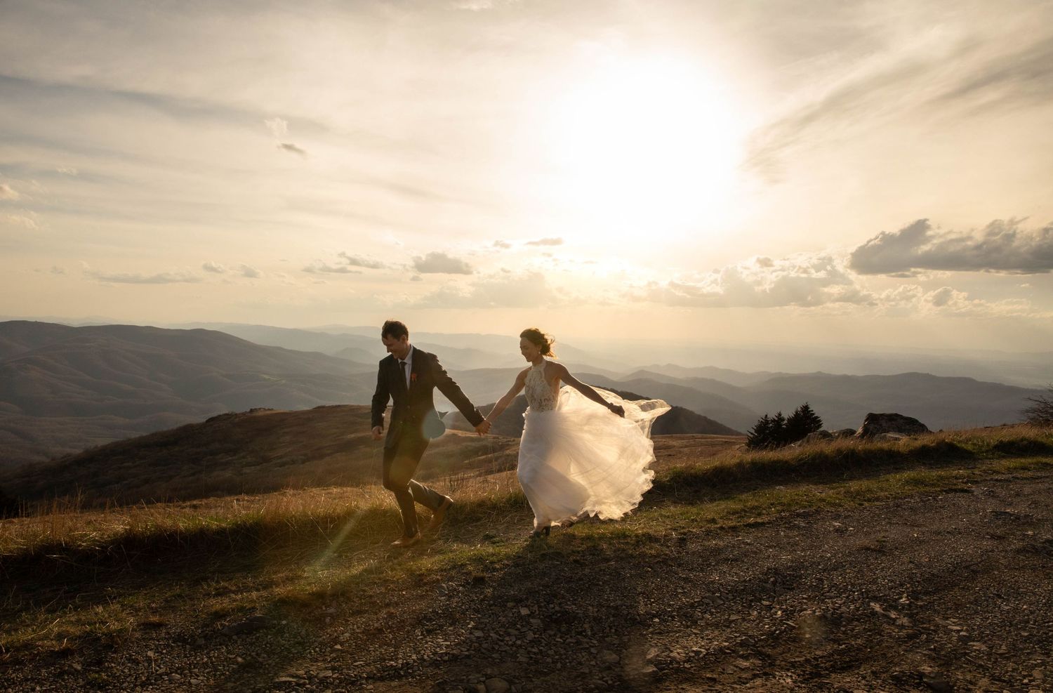 Photo of a bride holding a bouquet of yellow and orange flowers. Bridal session on Whitetop Mountain in southwest Virginia