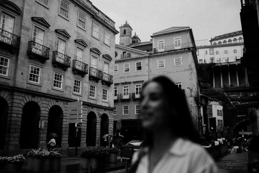 Cinematic engagement photo in the streets of Porto under soft rain