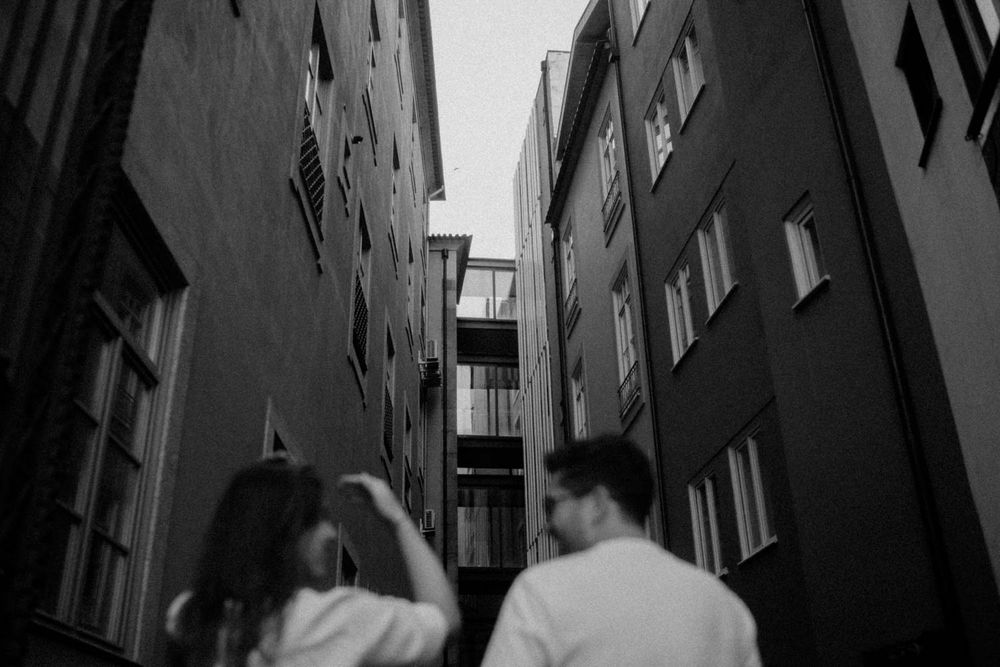 Cinematic engagement photo in the streets of Porto under soft rain