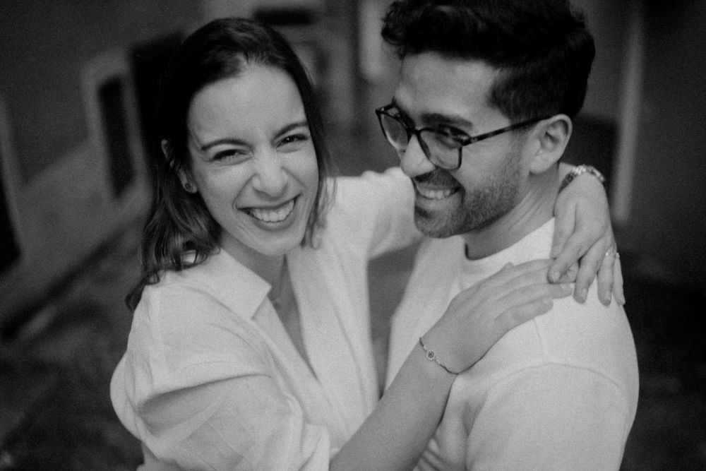 Candid moment between a couple during a rainy Porto pre wedding photo shoot