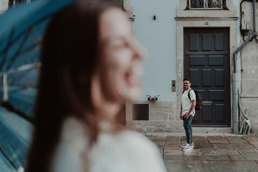 Candid moment between a couple during a rainy Porto photo session