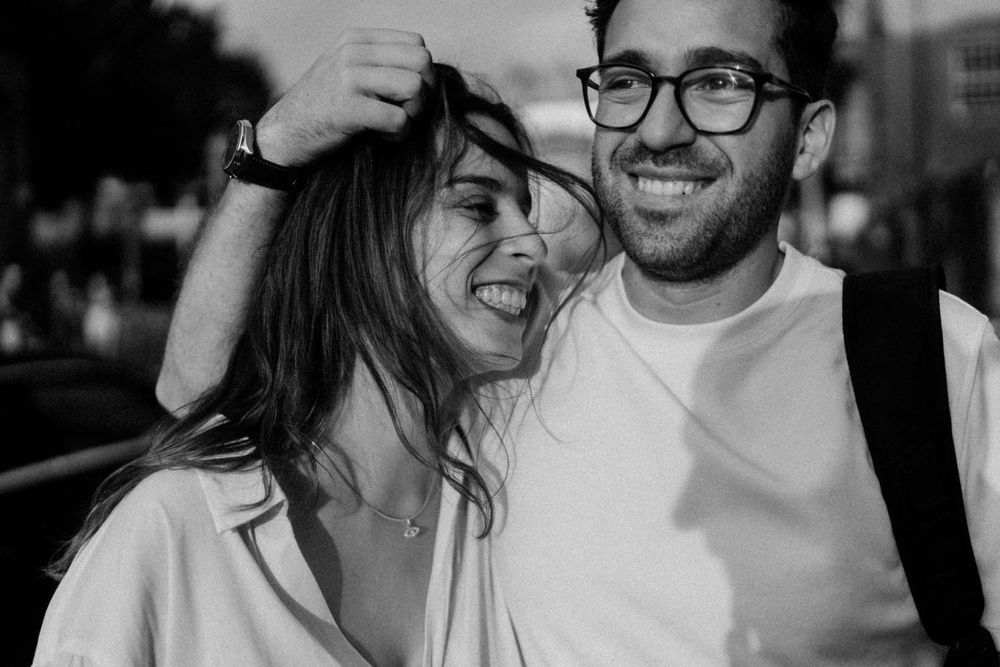 Candid moment between a couple during a rainy Porto photo session
