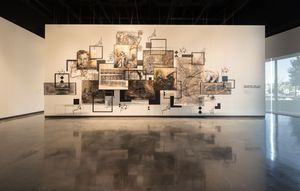 Large-scale mixed media wall installation featuring layered drawings and photographs in a spacious gallery.