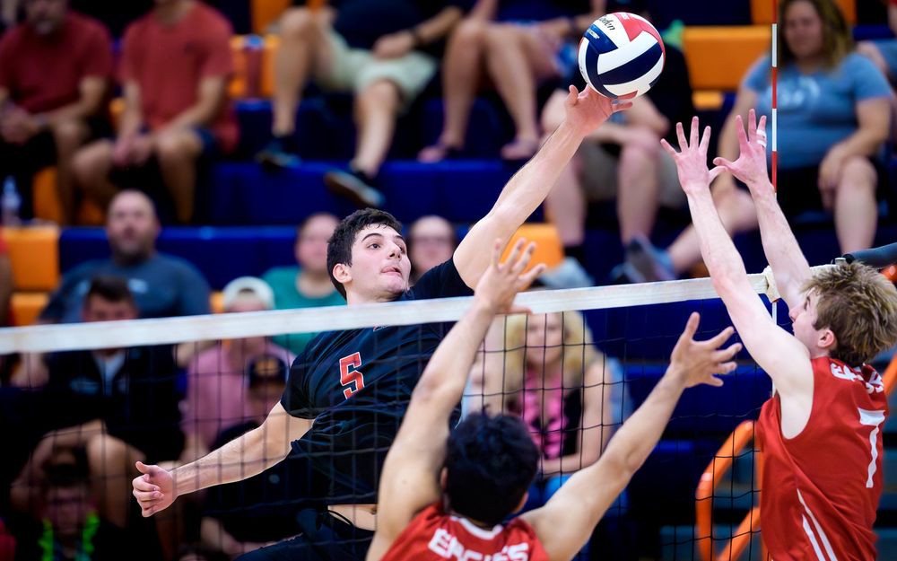 Hempfield attacks over Cumberland Valley block, PIAA boys volleyball semifinals by Deanna Fox, SportsFox Photography based in Hershey PA.