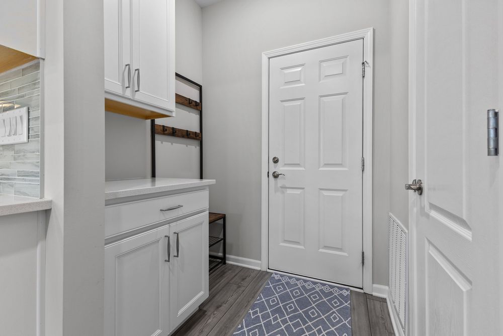 Modern kitchen with white quartz island and stainless appliances in Walled Lake townhome