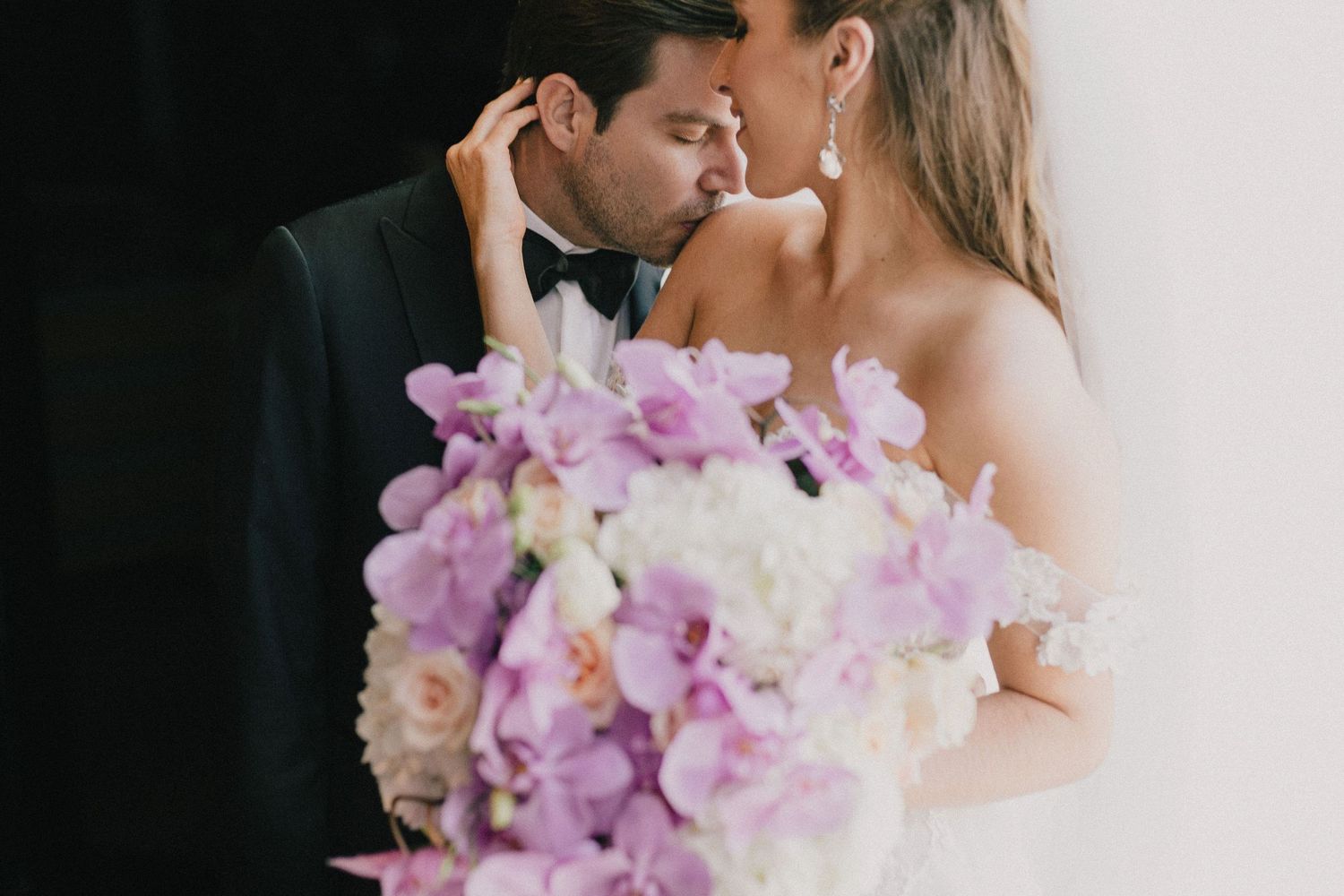 Intimate wedding photography with delicate floral arrangements and soft lighting.